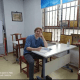 student sitting with book on table